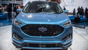 A blue 2018 Ford Focus on display at an auto show.