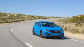 A Boost Blue Honda Civic Type R driving on a track