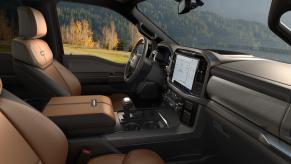 The brown leather interior of a Ford F-150 King Ranch pickup truck with its 10-speed automatic transmission shift lever visible.