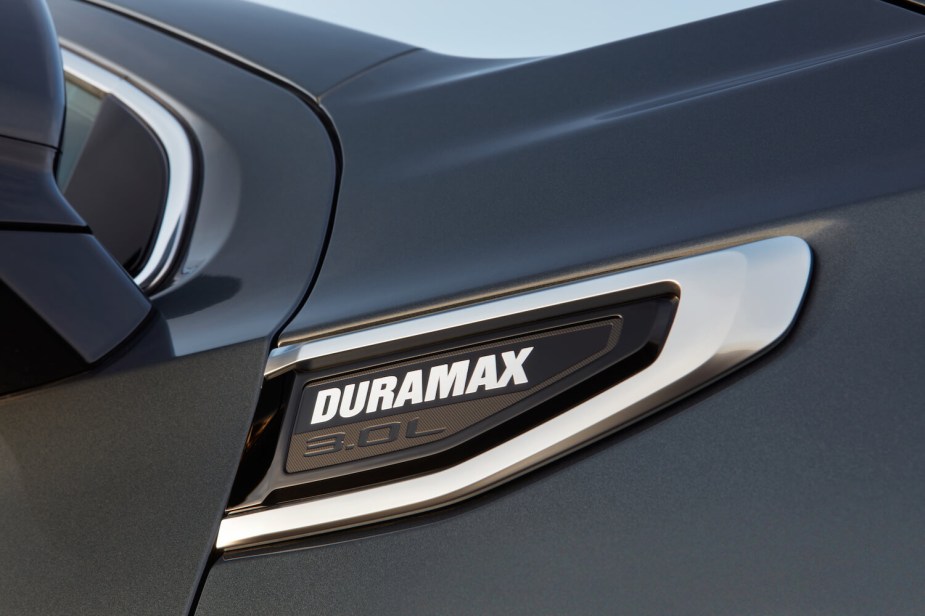 Closeup of the Duramax 3.0-liter diesel badge on the fender of a half-ton GMC pickup truck.