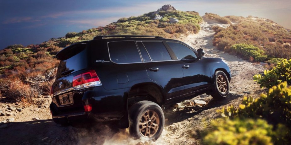 A blue 2021 Toyota Land Cruiser is driving off-road. 
