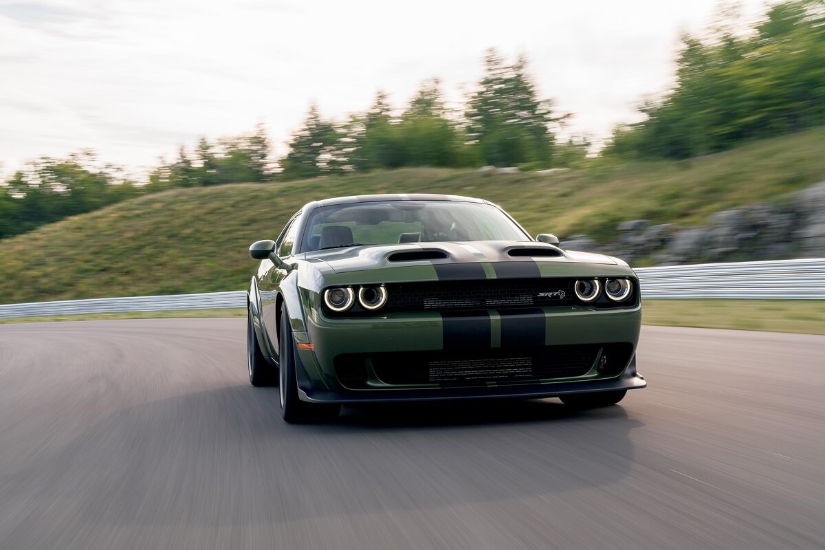 A 2022 Dodge Challenger SRT Hellcat Widebody in F8 Green shows off its muscle car proportions on a track. 