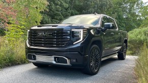 The GMC Sierra 1500 Denali Ultimate parked near foliage