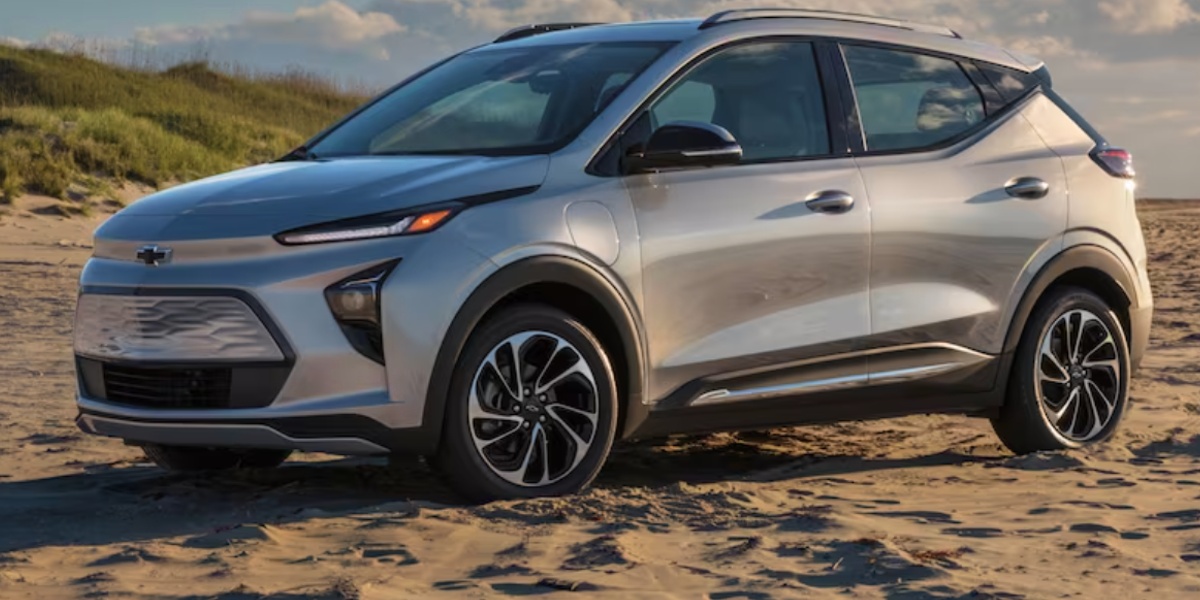 A gray 2023 Chevy Bolt EUV is parked on sand.