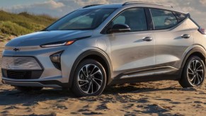 A gray 2023 Chevy Bolt EUV is parked on sand.