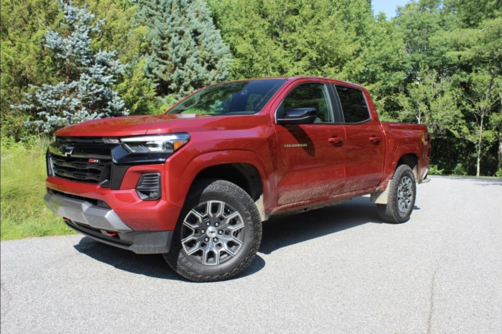 The 2023 Chevy Colorado Z71 parked on pavement near evergreen trees