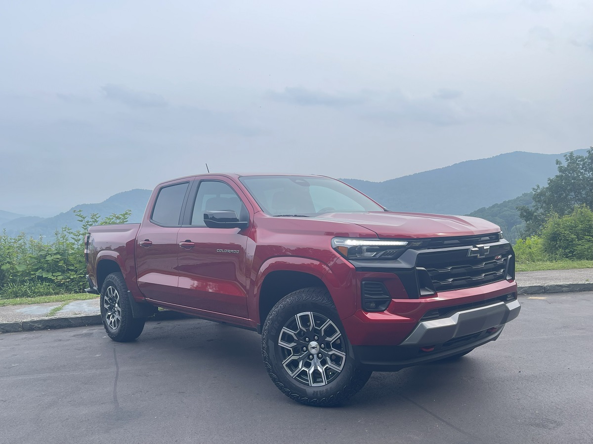 The 2023 Chevy Colorado Z71 in front of a scenic mountain view on a hazy day
