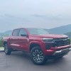The 2023 Chevy Colorado Z71 in front of a scenic mountain view on a hazy day