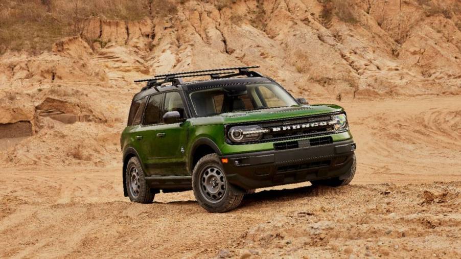 A green 2023 Ford Bronco Sport on display while off-roading.