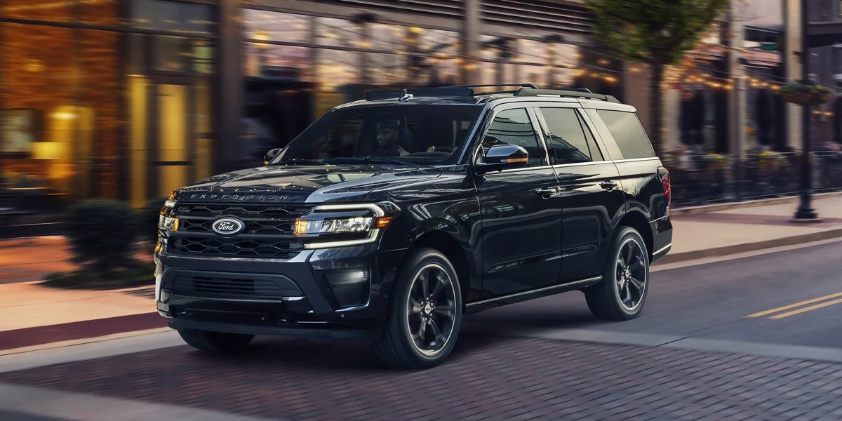 A black 2023 Ford Expedition full-size SUV is parked on the road.
