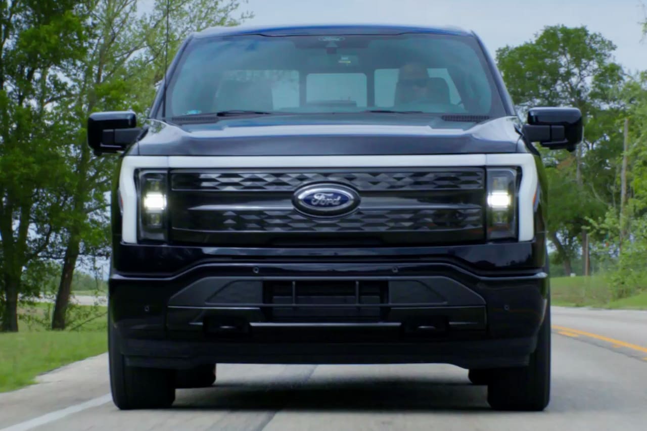 The face of the 2023 Ford F-150 Lightning with the LED bar lit up