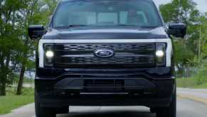 The face of the 2023 Ford F-150 Lightning with the LED bar lit up