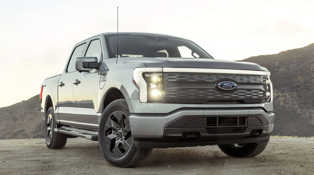The 2023 Ford F-150 Lightning parked on dispaly in the sand