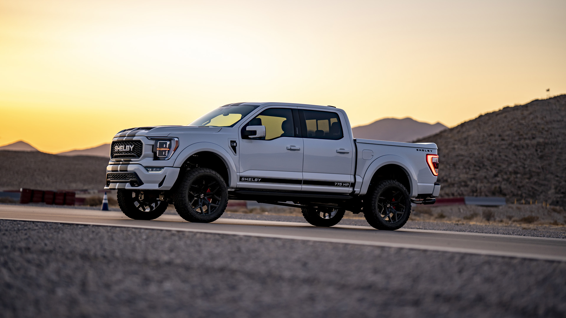 The 2023 Ford F-150 Shelby truck on the road at sunset