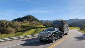 A 2023 GMC Sierra 3500HD towing a large travel trailer