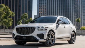 A white 2023 Genesis GV70 small luxury SUV is parked.