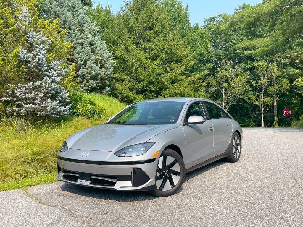 The 2023 Hyundai Ioniq 6 parked by evergreen trees