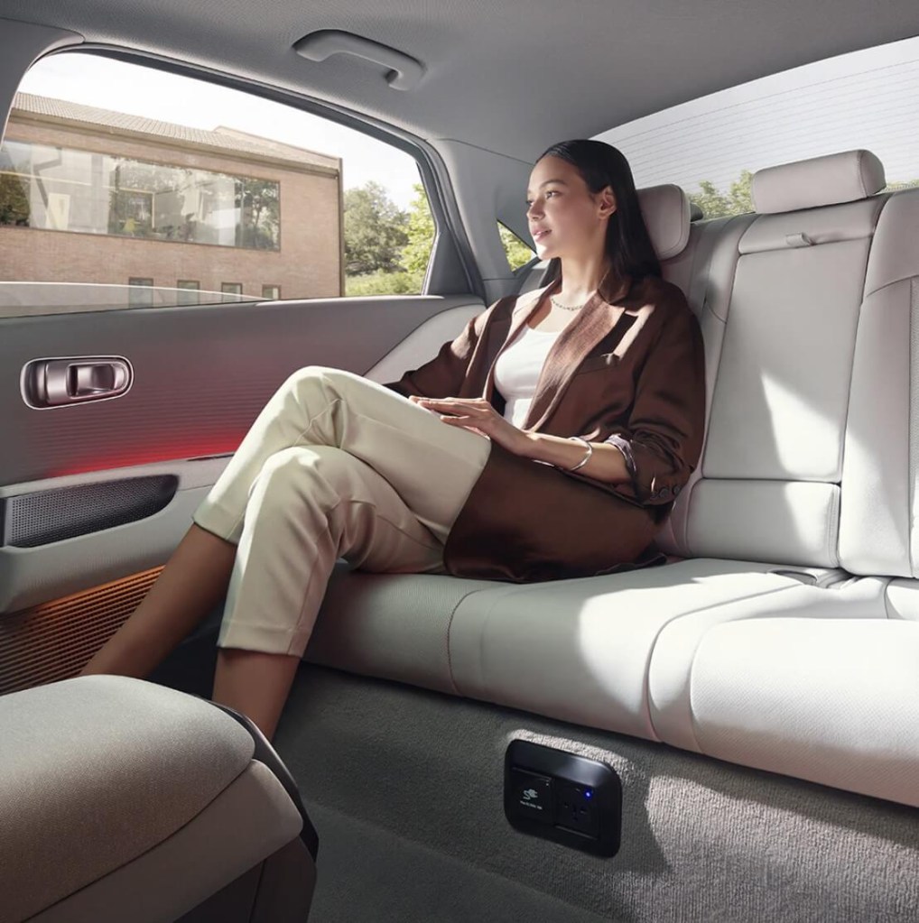 A woman relaxing in the backseat of the 2023 Hyundai Ioniq 6