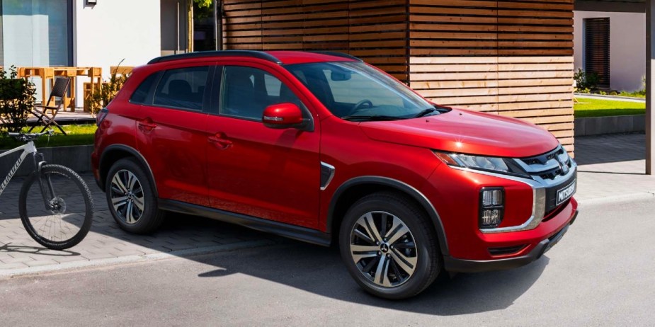 A red 2023 Mitsubishi Outlander Sport subcompact SUV is parked. 