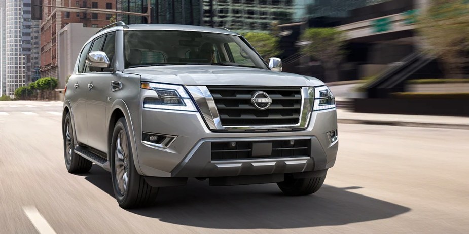 A gray 2023 Nissan Armada full-size SUV is driving on the road. 