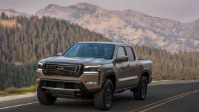 The 2023 Nissan Frontier on a scenic road in the mountains