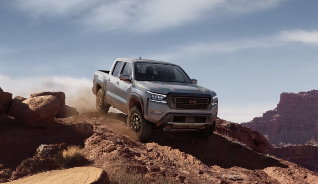 The 2023 Nissan Frontier off-roading over rocky terrain