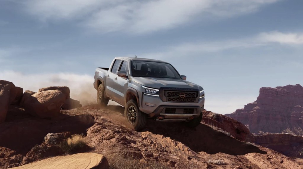 The 2023 Nissan Frontier off-roading on a mountain trail
