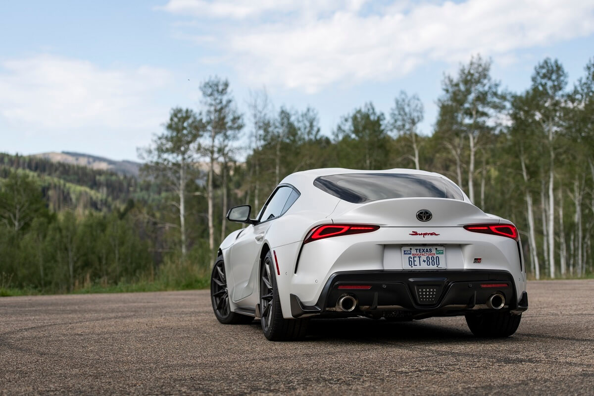 A white 2023 Toyota GR Supra 3.0 Mk5 shows off its rear-end styling.