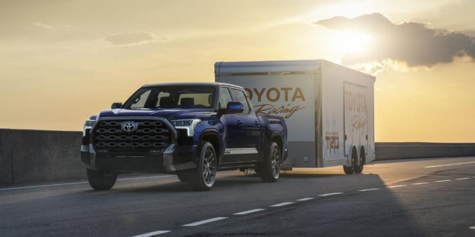 The 2023 Toyota Tundra towing a trailer down the road 