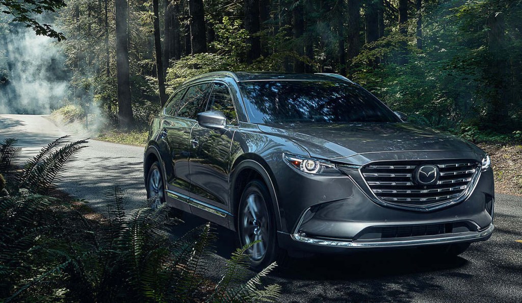 Charcoal 2023 Mazda CX-90 SUV with forrest background