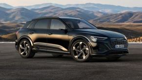 A dark-colored 2024 Audi SQ8 e-tron all-electric midsize luxury SUV model