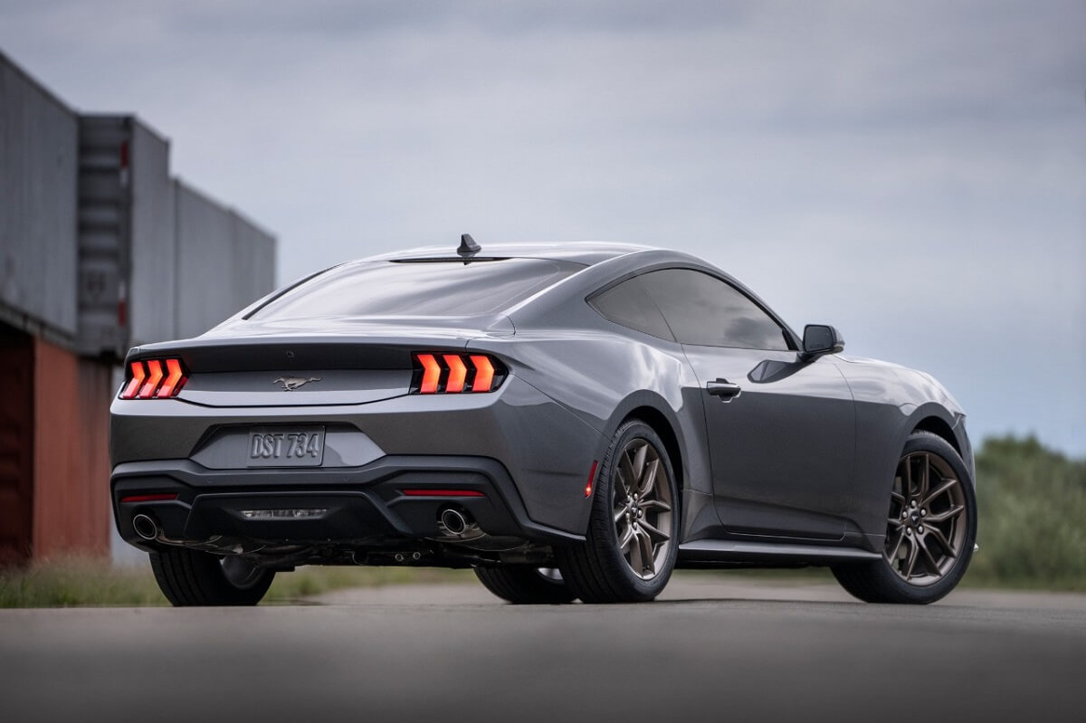 A gray 2024 Ford Mustang EcoBoost shows off its rear-end styling. 