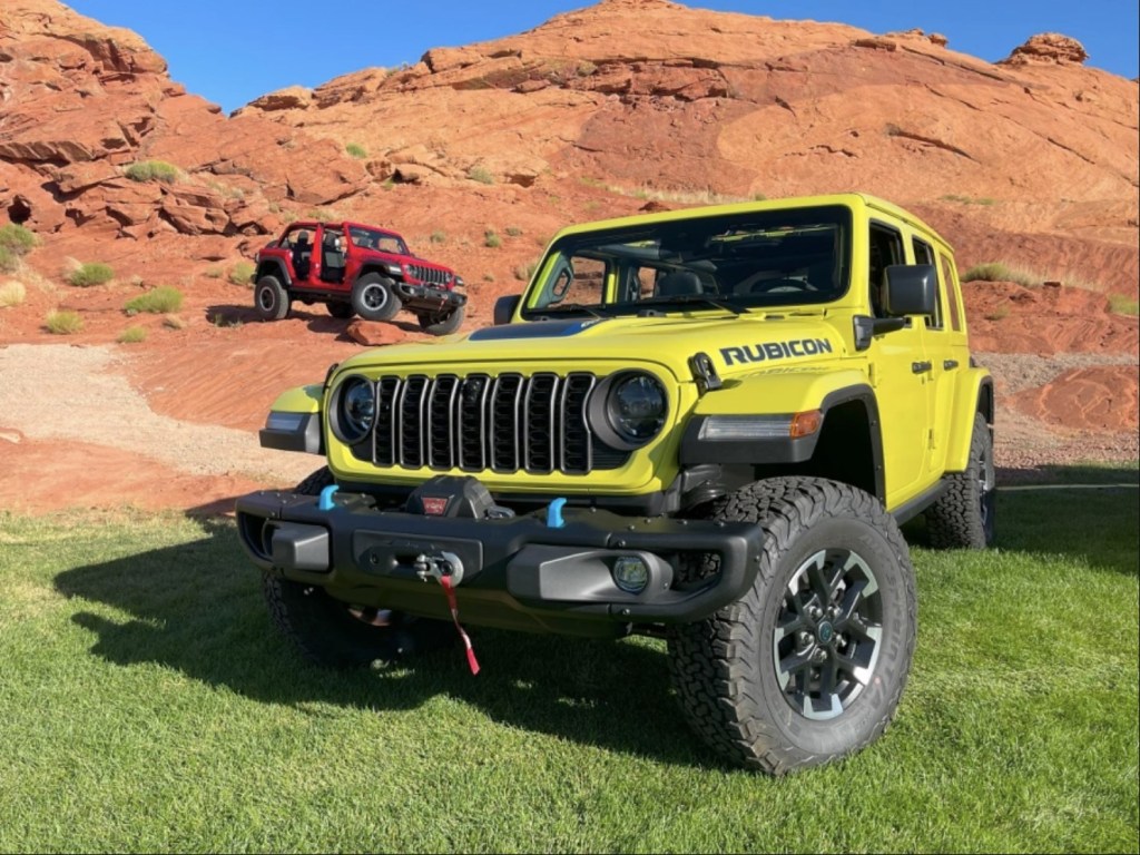 Two 2024 Jeep Wrangler models parked in the desert 