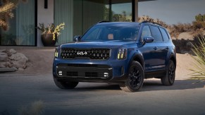A blue 2024 Kia Telluride is parked outdoors.