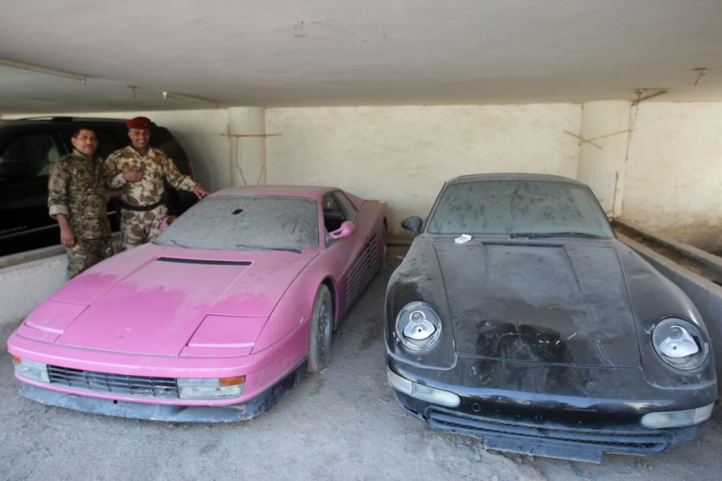 Dirty pink Ferrari Testarossa with other dirty sports cars