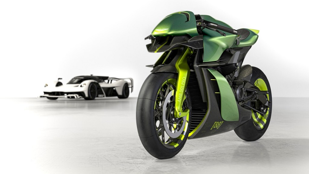 A green Aston Martin Brough Superior AMB 001 superbike motorcycle parks next to Valkyrie AMR.
