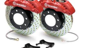 A set of aftermarket Brembo drilled and slotted performance brake rotors and calipers.