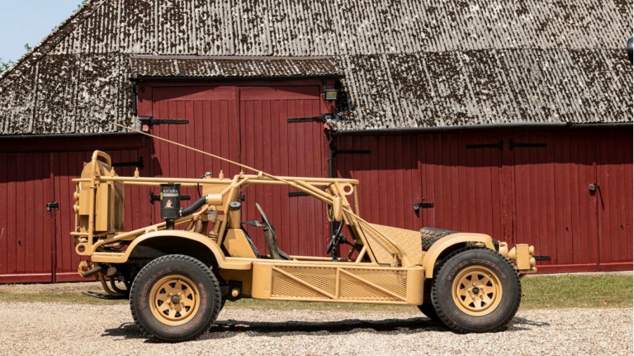 British SAS Dune Buggy parked in front of a barn in profile