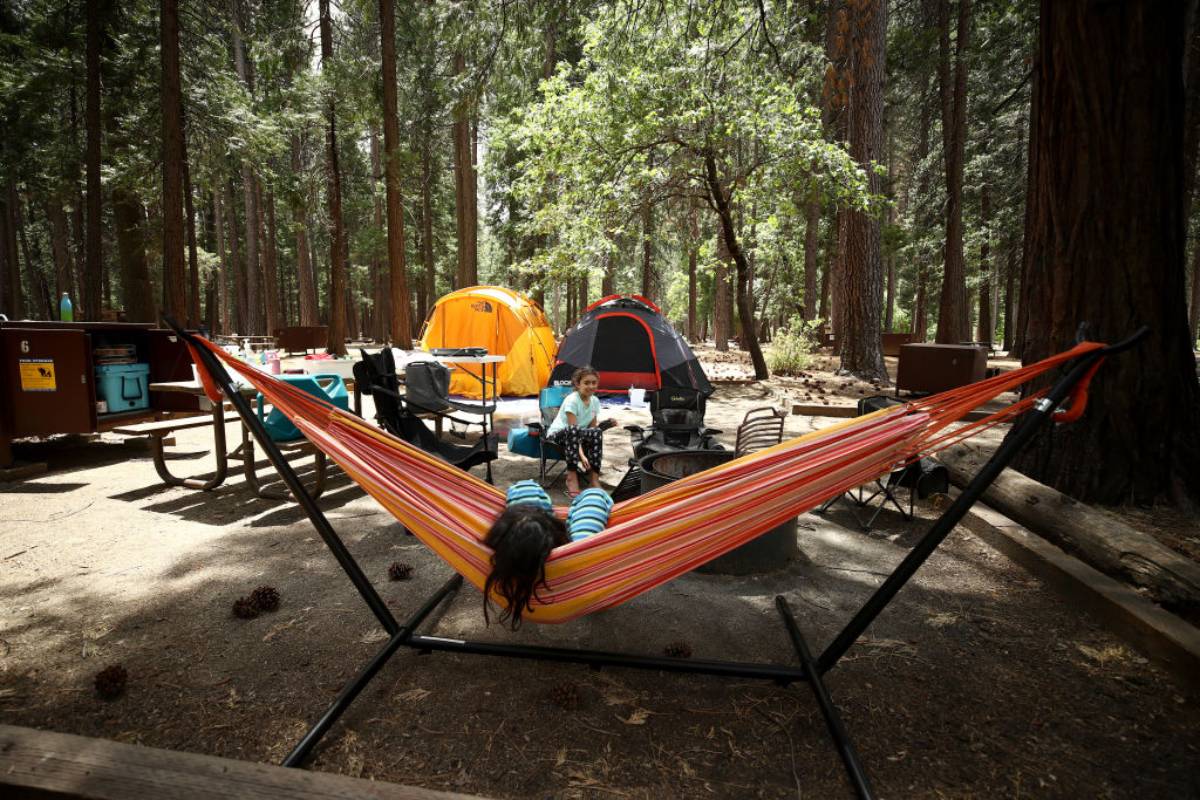 People relaxing at their camp site on a campground.
