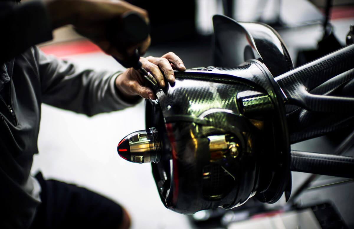 The McLaren Formula One racing team working on the left brake of a MP4-29 car for the 2014 Canadian Grand Prix