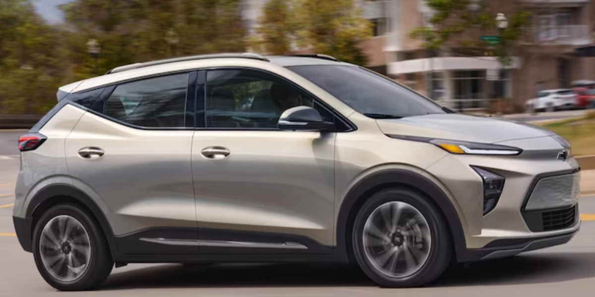 A gray 2023 Chevrolet Bolt EUV subcompact electric SUV is driving.