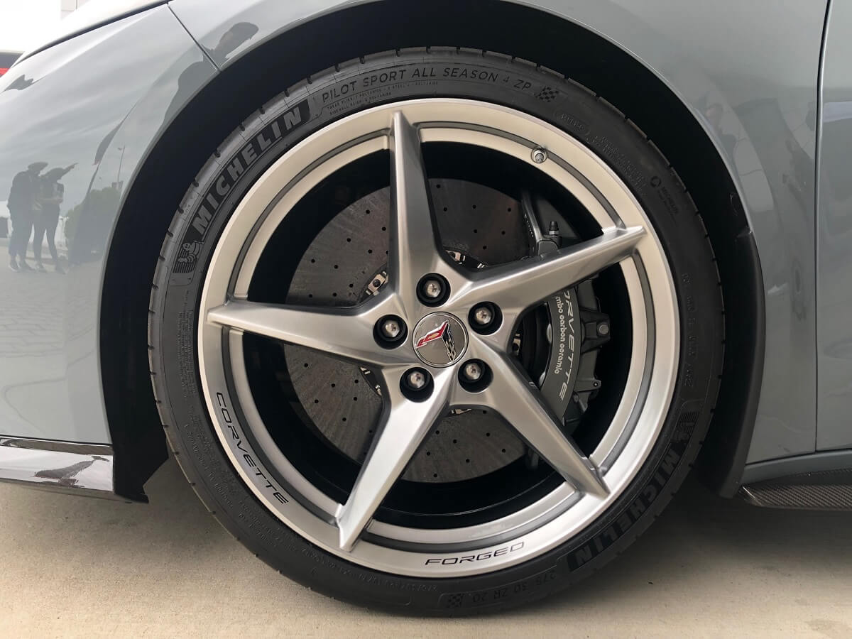 A Chevrolet Corvette E-Ray flashes its performance drilled and slotted carbon-ceramic brake rotors and wheels. 