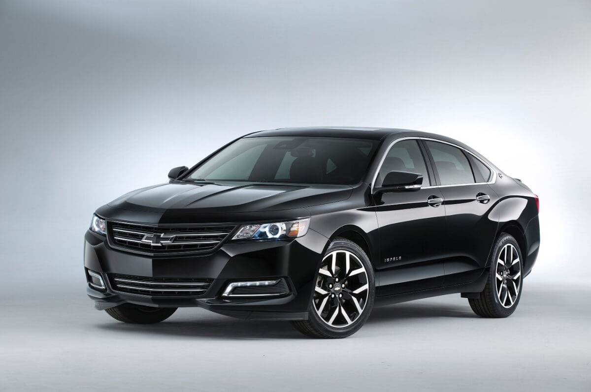 A black 2020 Chevrolet Impala shows off its front-end styling on a stage.