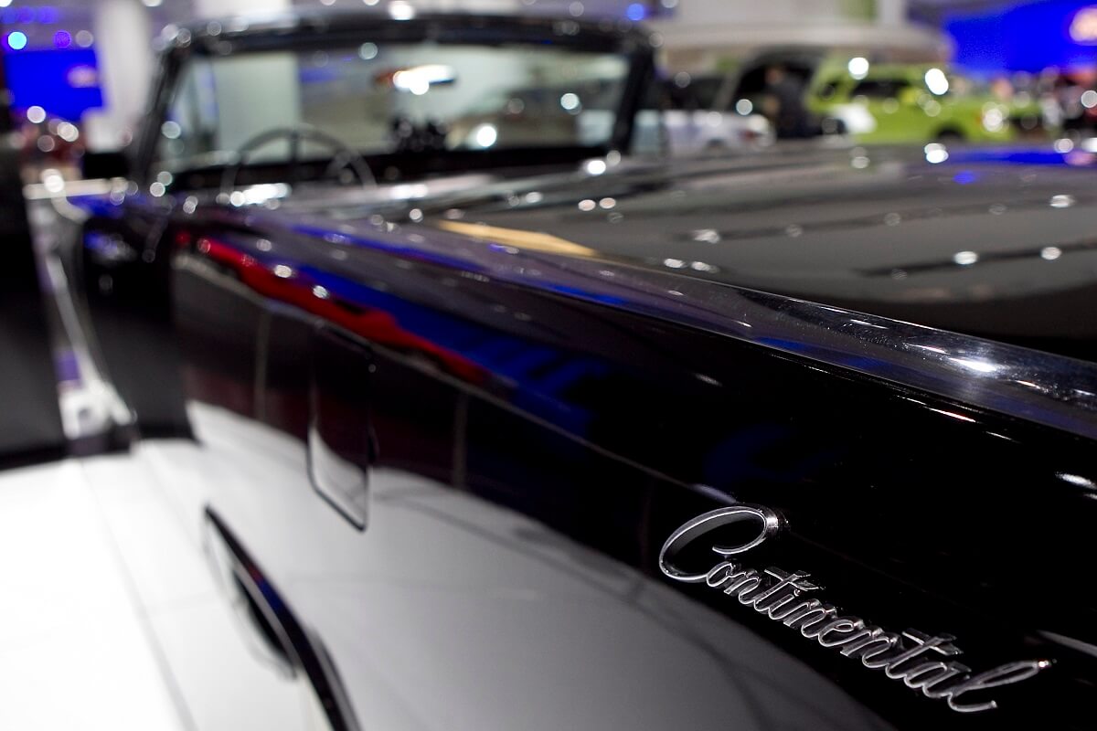 A dark blue Lincoln Continental Convertible shows off its badge.