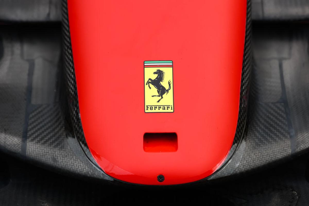 A Ferrari logo on the hood of a red and black car.
