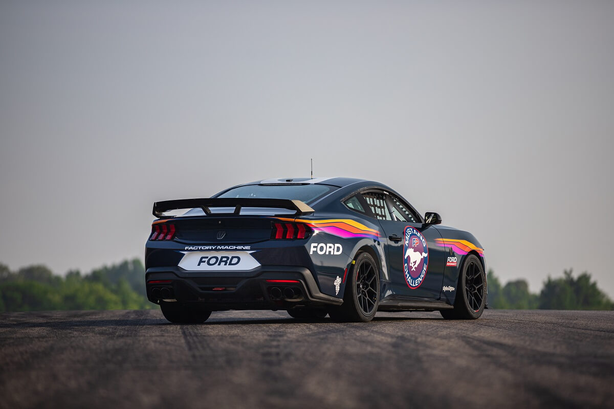 A Ford Mustang Dark Horse R shows off its new livery on a track.