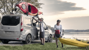 A couple transporting kayaks to a body of water using a 2023 Ford Transit Connect Titanium