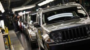 A row of Jeep Liberty SUVs on the assembly line.