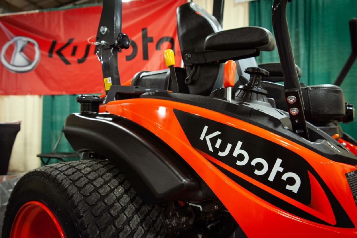 An orange and black Kubota riding zero-turn lawn mower shows off its bright colors. 