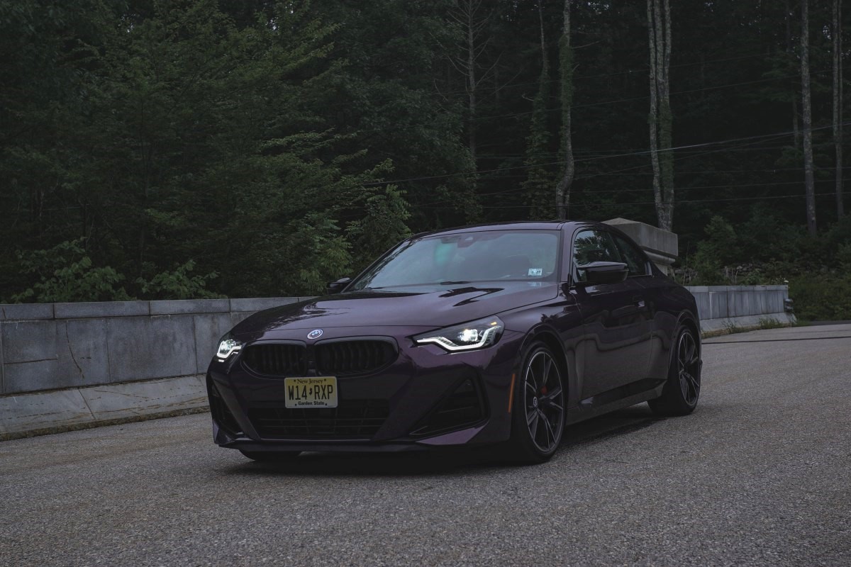 A 2023 BMW M240i in Thundernight Metallic parked on a side street